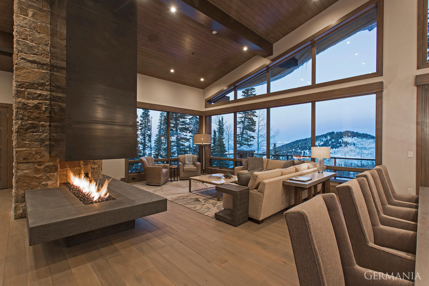 When building your custom luxury home dining room, consider all the parts to maximize your mountain living experience. Fireplace and tongue and groove ceilings can augment any view!