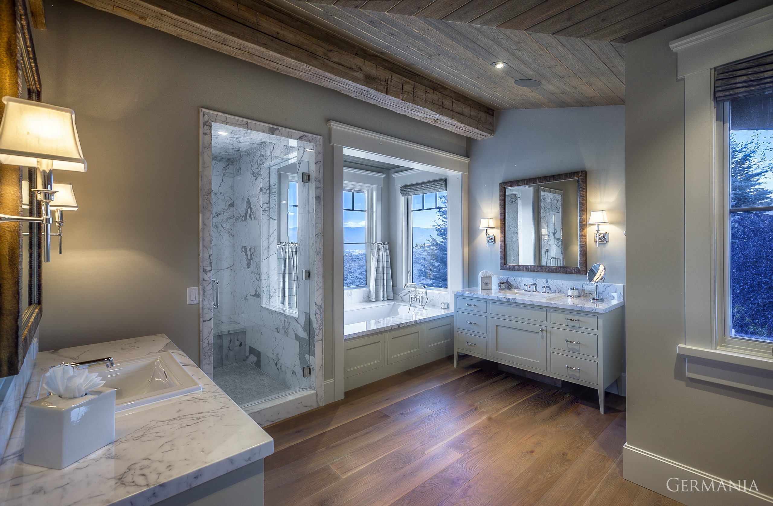 With this custom house bathroom design, Germania Construction emphasied the importance of the bathtub, shower, and tongue and groove ceiling complementing each other. Luxurious views require luxury homes.