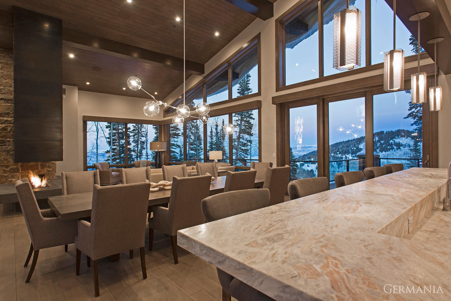 This is what you want in a vacation home dining room. Stone slab countertops and tongue and groove ceilings and that amazing mountain living view!