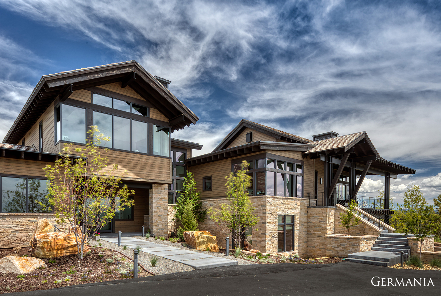 Considering building a custom luxury home? Featured here is one of many luxury builds by Germania. The driveway, stone veneer, and custom walk paths are some of the craftmanship you can expect.