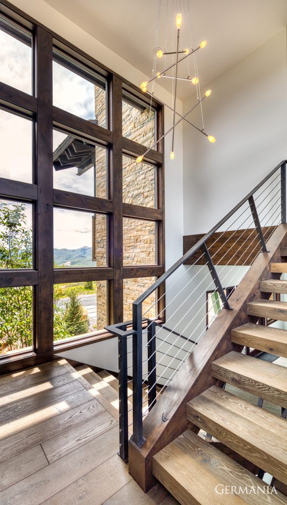 Featured here is a custom railing with unique wood stairs. What makes this space memorable is the incredible work with the windows. We love how they turned out.