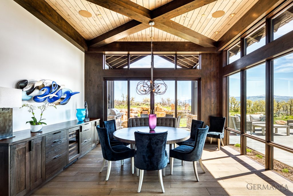 This is a custom home dining room. Wood beams, tongue and groove ceilings, and custom cabinets are just a few of the many features Germania are masters at.