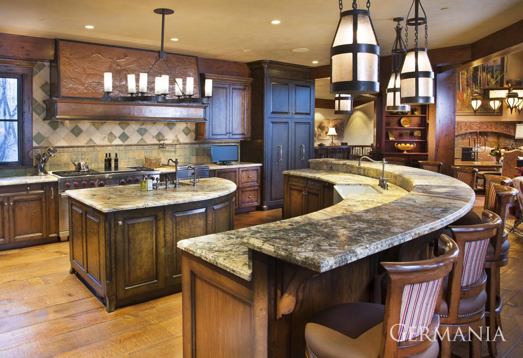In this custom home kitchen, pay attention to everything. The stone countertops, custom cabintery, custom lighting, and how well the kitchen complements the rest of this luxury home.