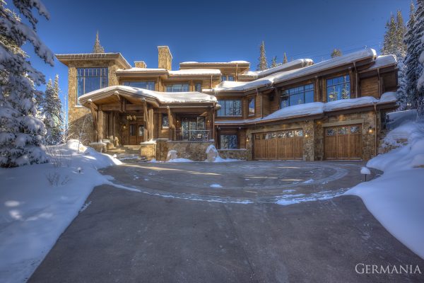 In this high end custom home, the exteriors include custom siding and custom luxury garage doors.