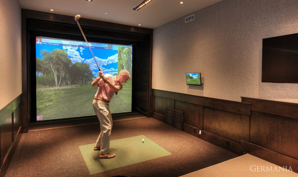 Featured here is a golf simulator. One of the many design elements to consider when building your dream house.