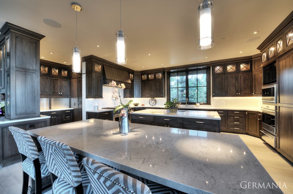 In this custom luxury home kitchen in Park City, the light fixtures, cabinets, and countertops all pair well together.