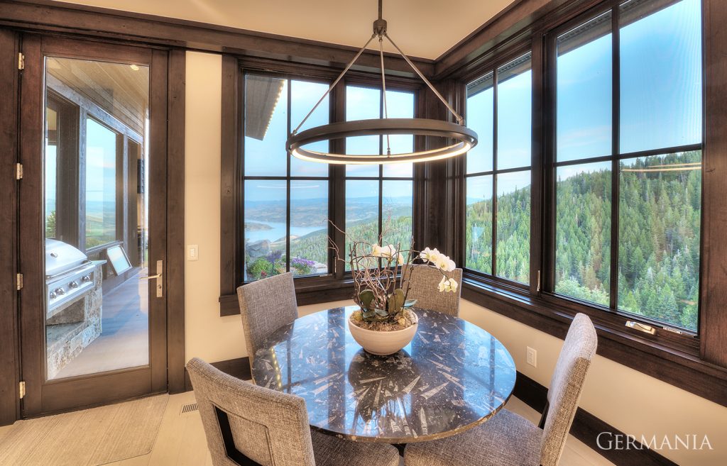 This image shows what you can expect in a custom made home dining room from Germania. Doors, windows and light fixtures are all part of the many things we consider with design and construction.