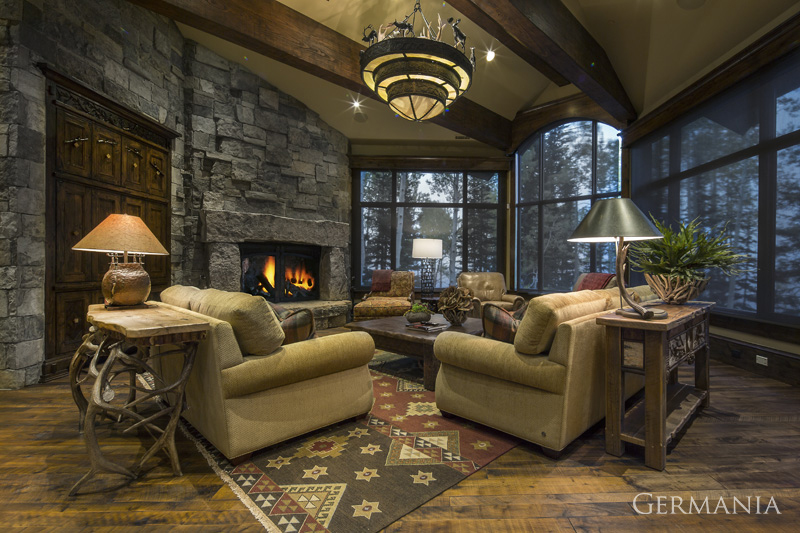 Pay attention to every detail when building your custom weekend getaway home's living room. This custom living room in Park City Utah features impressive stone work, wood floors, and beautiful wood beams towering above.