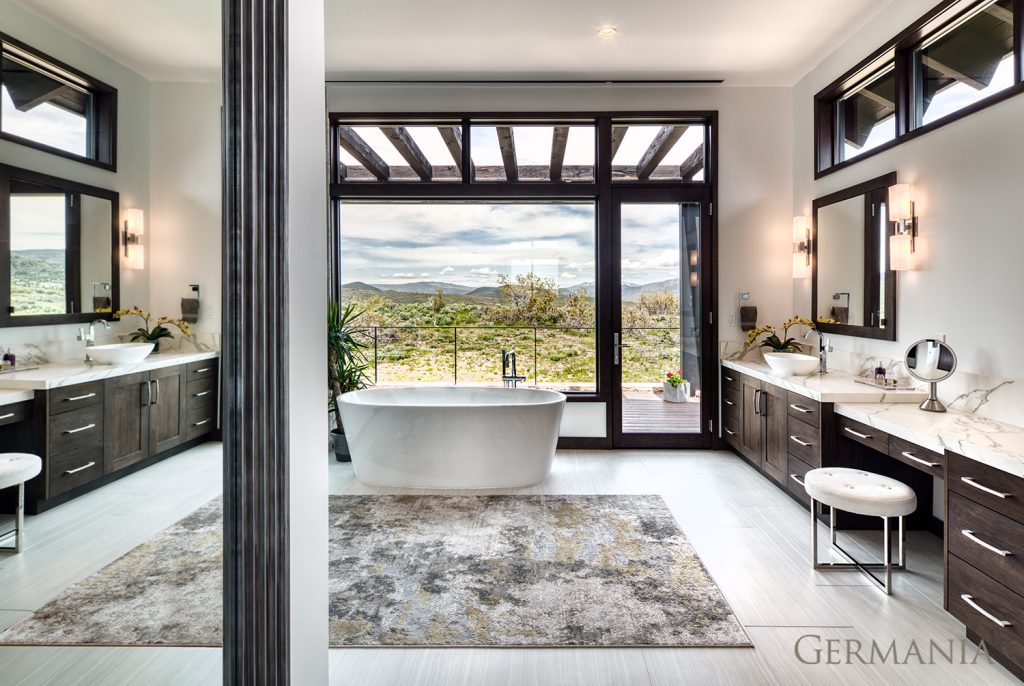 The design of this custom master bathroom for a weekend getaway home incorporates a soaker tub, his and hers sinks and stunning design.