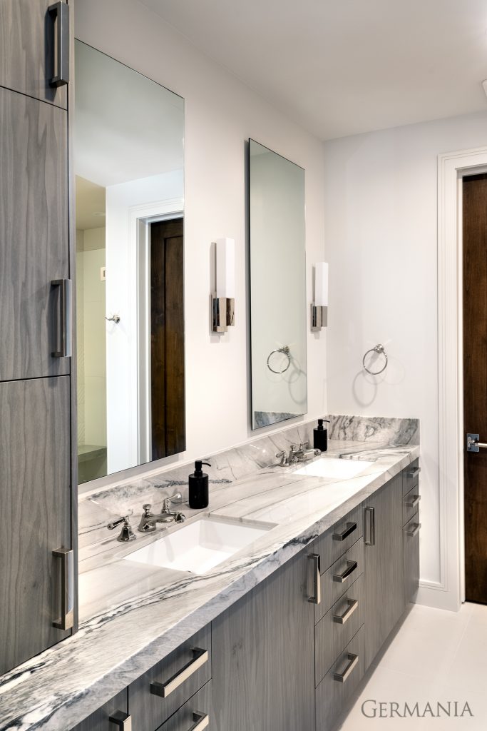 This double sink and vanity offers lots of space and storage in this modern guest bathroom.