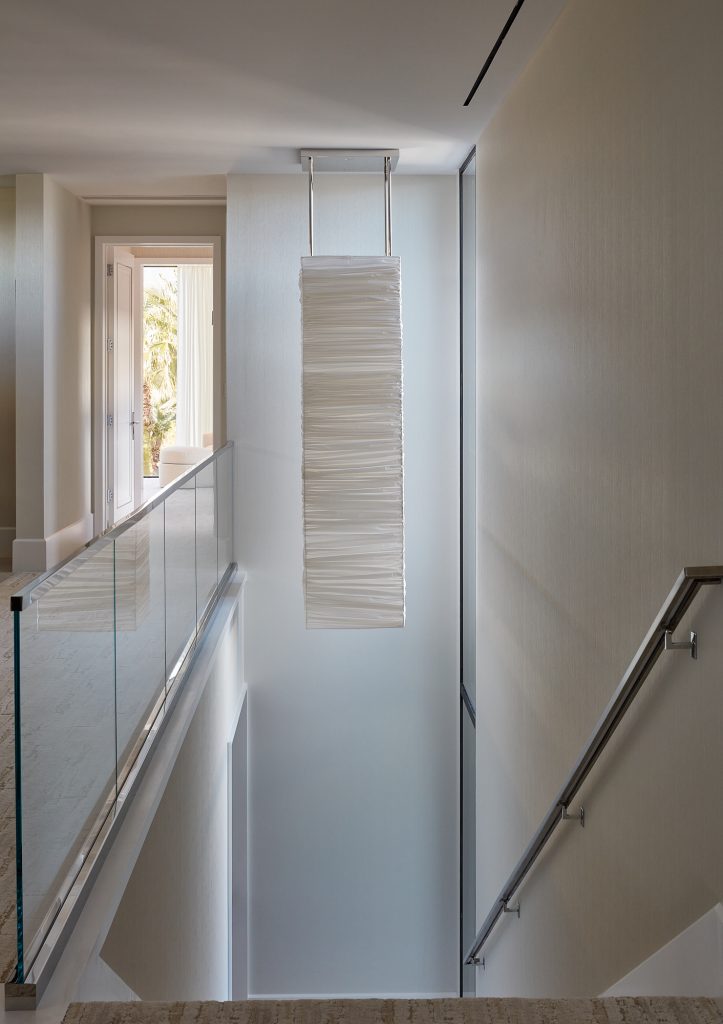 A large chandelier provides visual interest from above and below on this stairway.