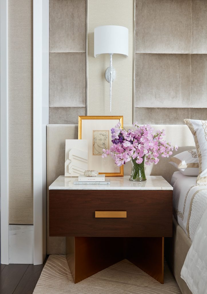 The details of this nightstand add to the elegance of this custom master bedroom.