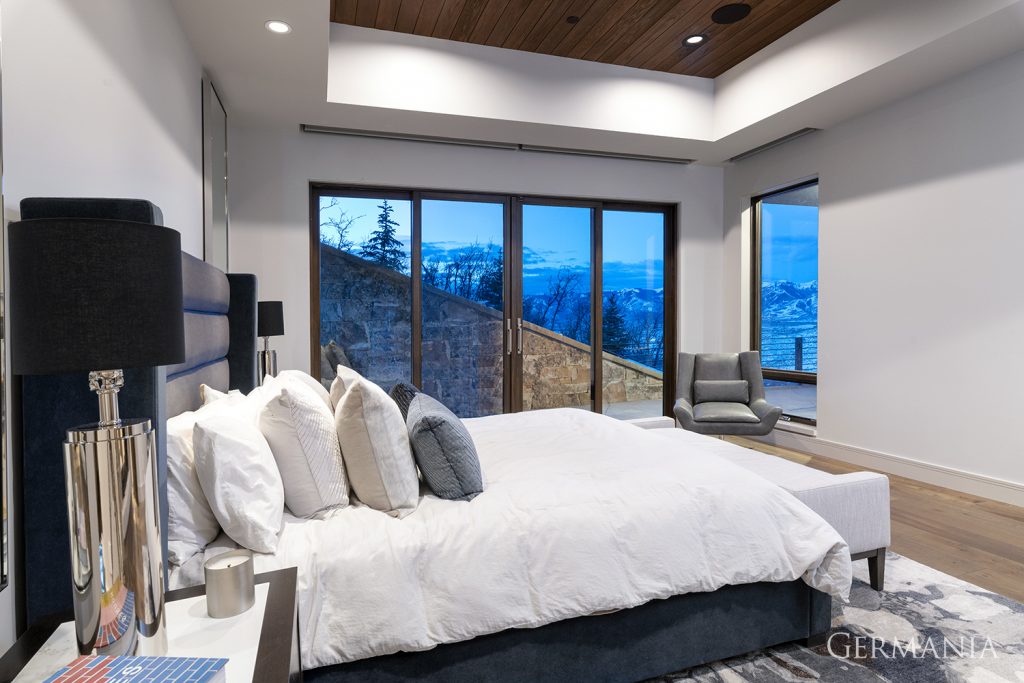 A tray ceiling and French patio doors complete the look of this clean and simple bedroom.