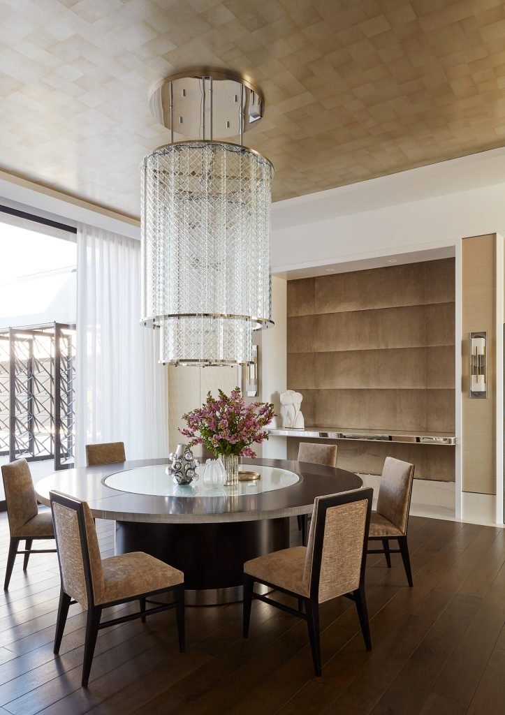 Gather around this round table to share a bite in this elegant custom dining room.