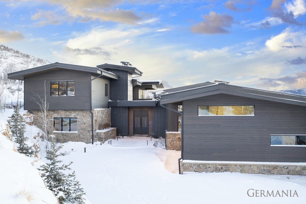 The snow covered front entrance makes this custom home look even more cozy and inviting.