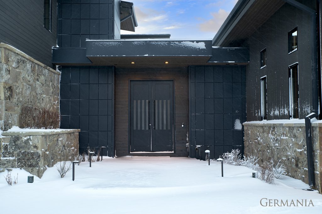 The snow only adds more drama to this inviting front door space.