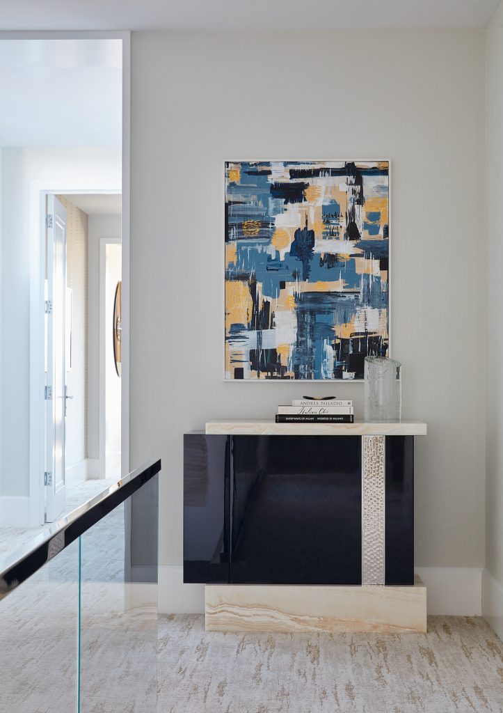 Custom artwork greets you at the top of this modern staircase.