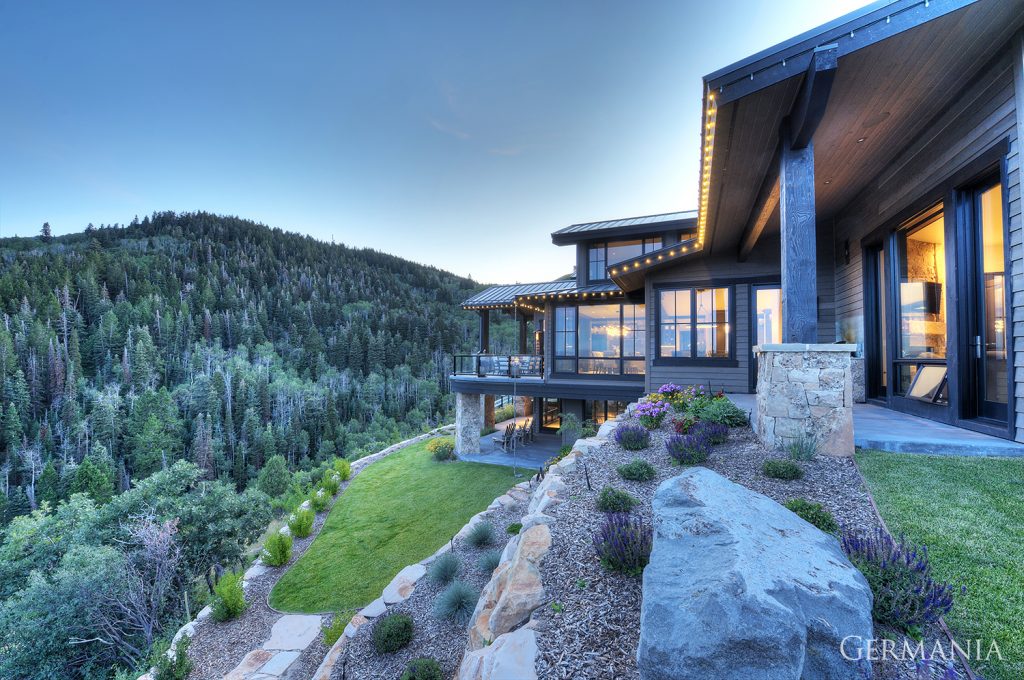 Luxury, custom-built home deck in Park City, UT. Nestled in the mountains and surrounded by a landscaped yard.