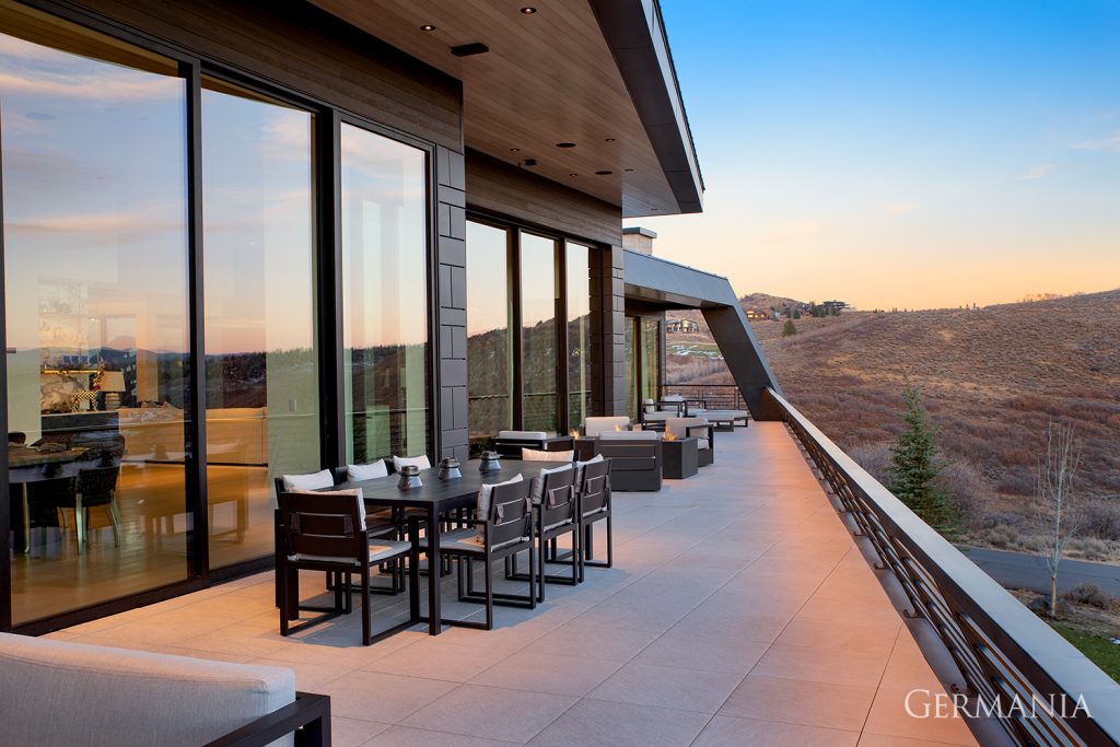 Stunning, luxury, custom-built deck in Park City, UT with amazing views of the mountains at sunset.