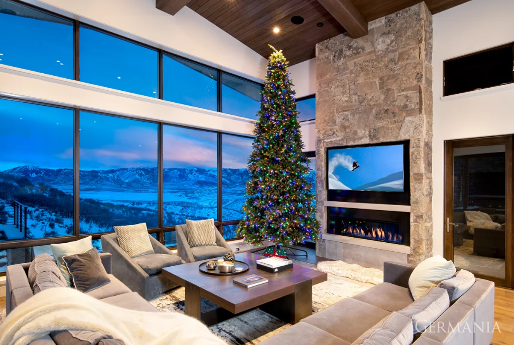 The TV in this room will have a hard time holding everyone’s attention since it has to compete with the perfectly placed oversized windows that frame the gorgeous mountains outside. 