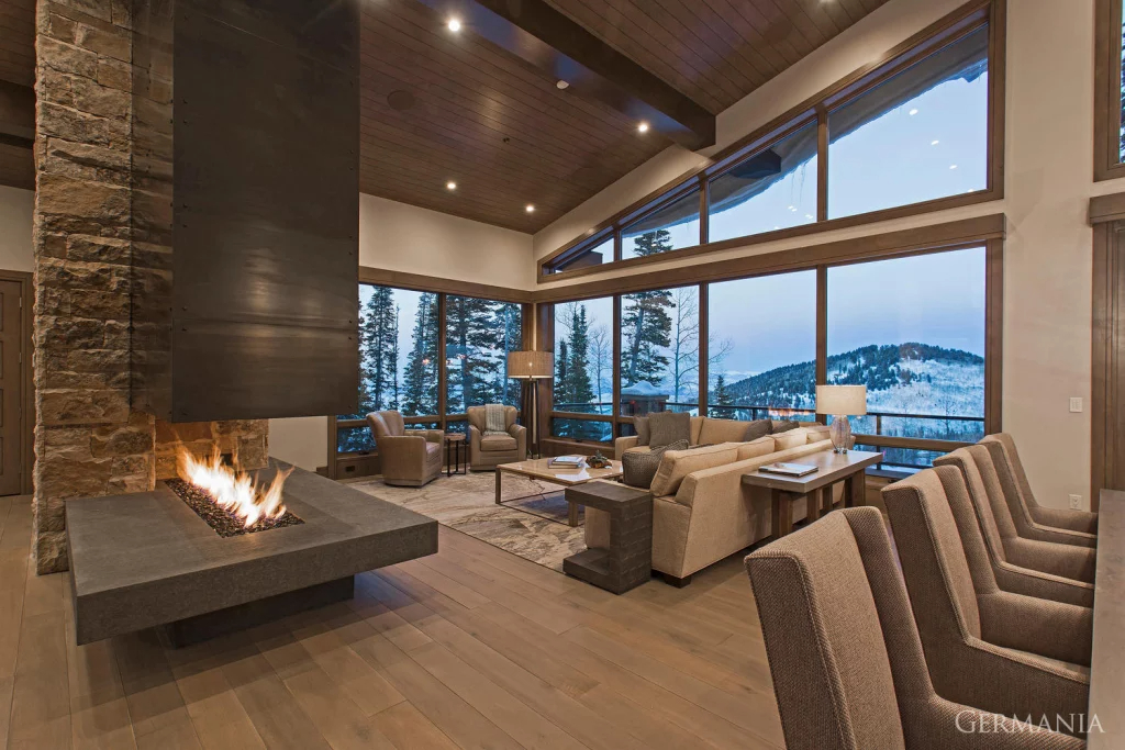 The living room of a luxury, custom-built home in Park City UT with access to Park City Mountain. The interior is grey and light brown.
